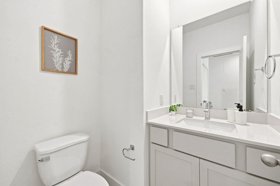 Bright and stylish powder room with modern vanity, contemporary fixtures, and clean finishes. Bright and stylish powder room with modern vanity, contemporary fixtures, and clean finishes.