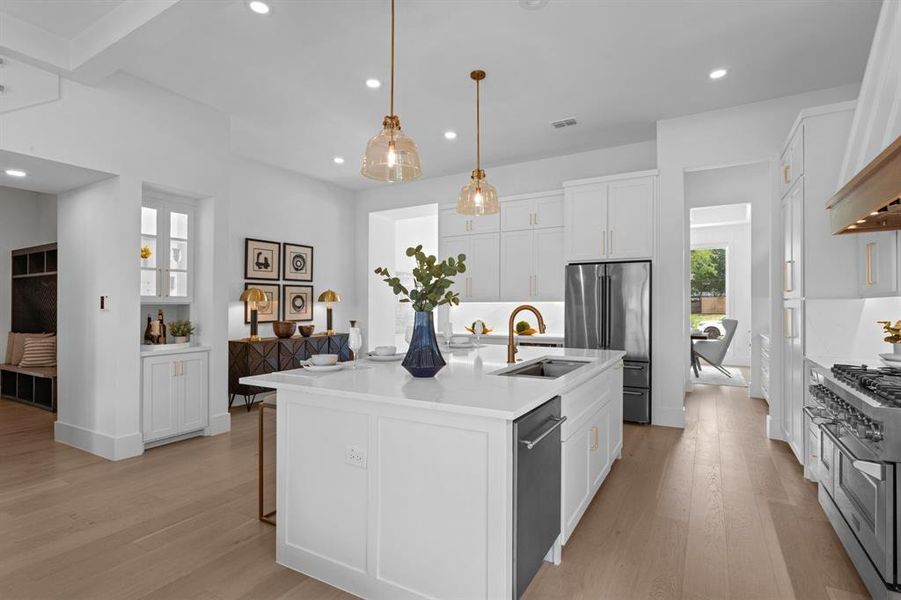 Kitchen with premium appliances, 6 burner gas stove with large griddle and 2 ovens, pot filler and gold accents throughout Kitchen with premium appliances, 6 burner gas stove with large griddle and 2 ovens, pot filler and gold accents throughout