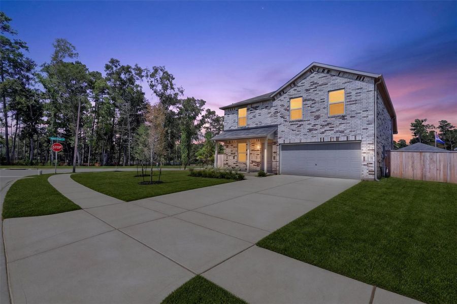 As the day winds down, the home's exterior takes on an especially welcoming glow.