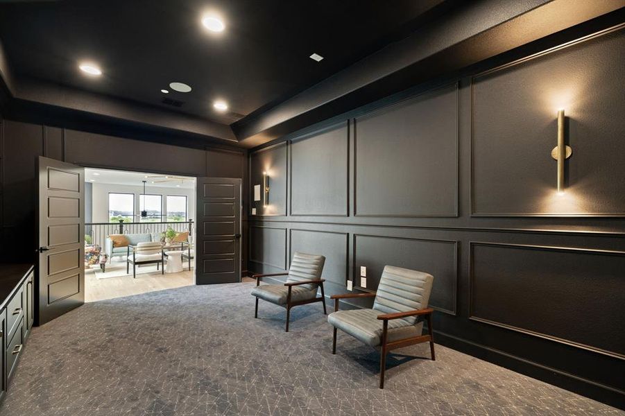 Sitting room featuring a decorative wall and a tray ceiling Sitting room featuring a decorative wall and a tray ceiling