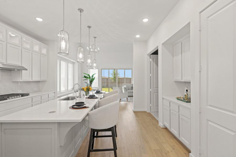 This kitchen conveniently connects to the breakfast area, media, and living room for easy entertaining!