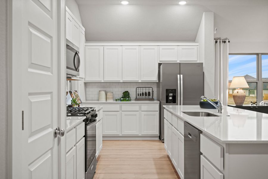 Kitchen in the Diamond home plan by Trophy Signature Homes – REPRESENTATIVE PHOTO