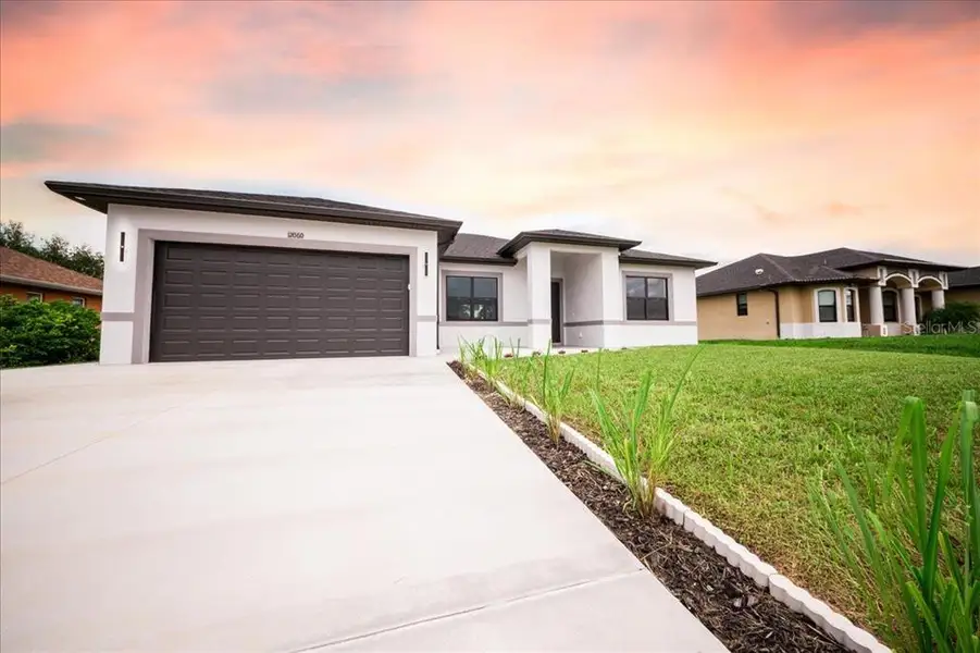 Front exterior of a new home in , North Port, FL, highlighting curb appeal (Image 32). Front exterior of a new home in , North Port, FL, highlighting curb appeal (Image 32).
