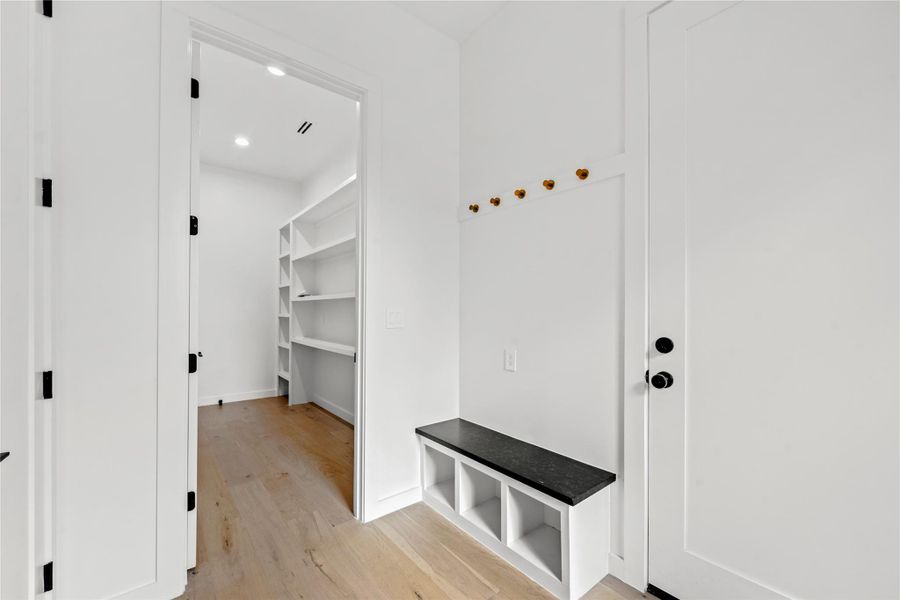 Mudroom featuring light wood-type flooring and recessed lighting