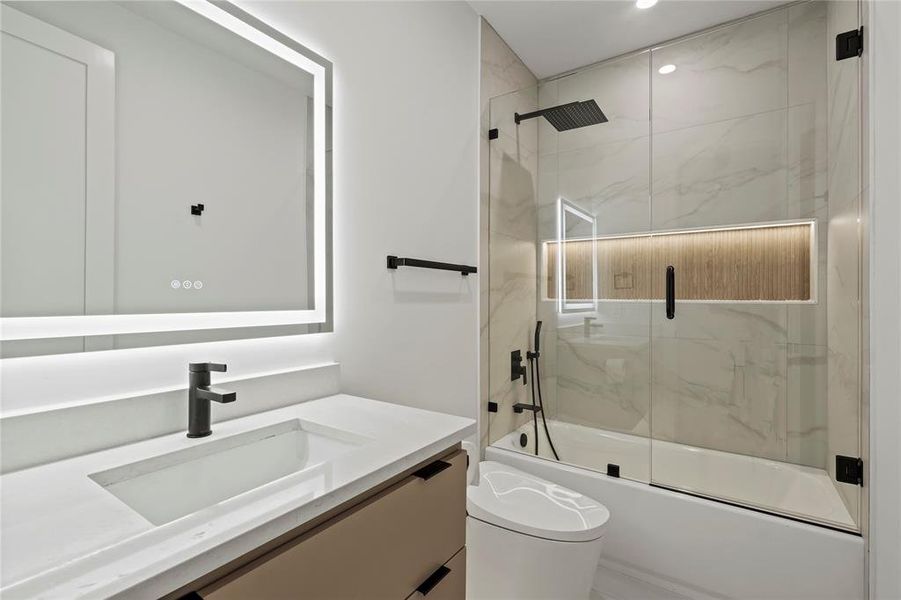 Bathroom with vanity, combined bath / shower with glass door, and recessed lighting