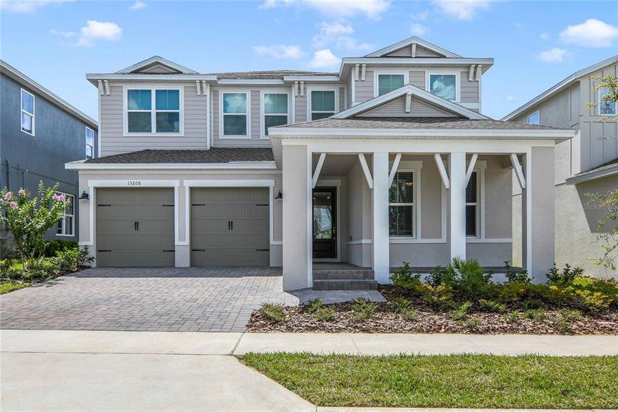 Front exterior of a new home in Horizon Isle, Winter Garden, FL, highlighting curb appeal (Image 1). Front exterior of a new home in Horizon Isle, Winter Garden, FL, highlighting curb appeal (Image 1).