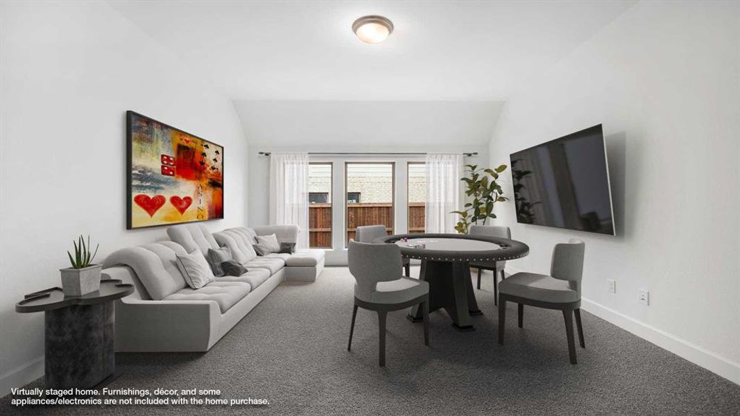 Carpeted living room featuring vaulted ceiling and baseboards