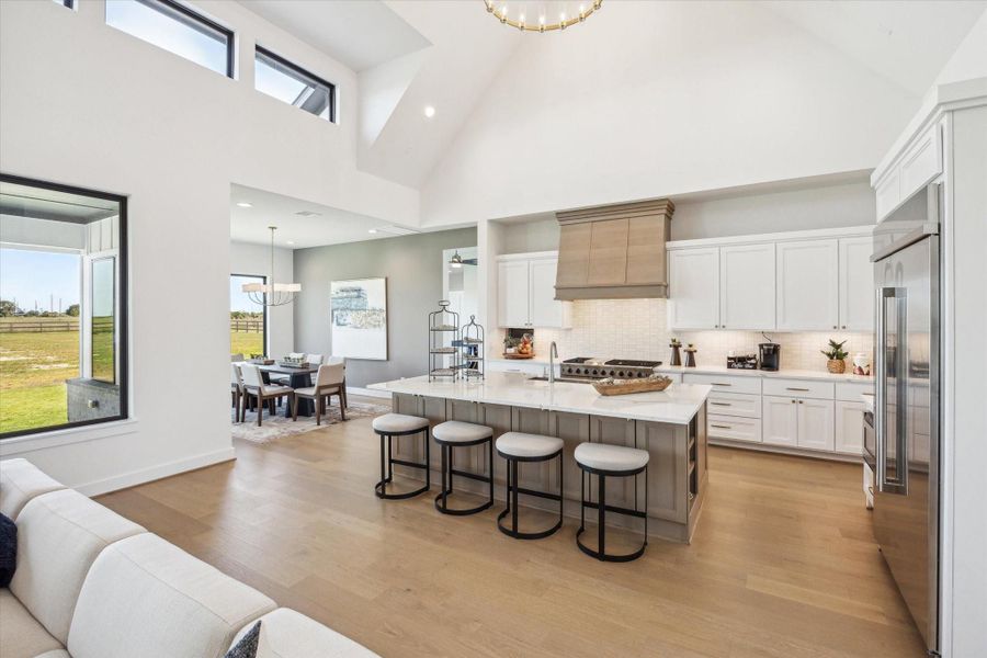 Kitchen with massive island with space for seating, custom built cabinetry, and high-end appliances. Kitchen with massive island with space for seating, custom built cabinetry, and high-end appliances.