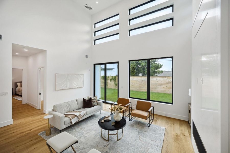 Family room with tall ceilings, natural light, and sleek finishes. Family room with tall ceilings, natural light, and sleek finishes.