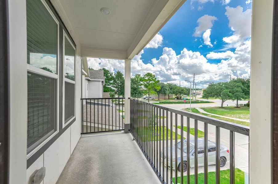 Covered balcony with a view off the front of the home. Covered balcony with a view off the front of the home.