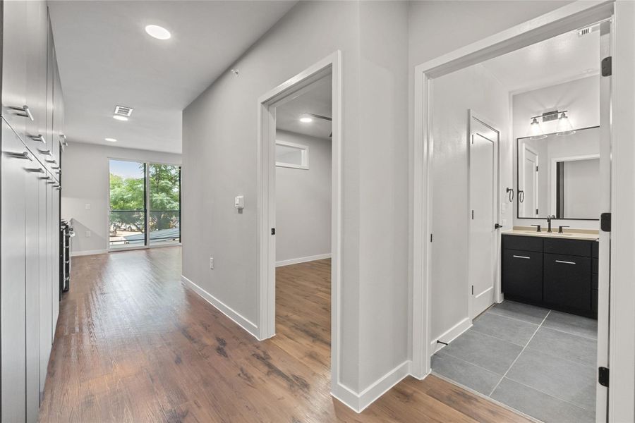 Corridor featuring wood finished floors and recessed lighting