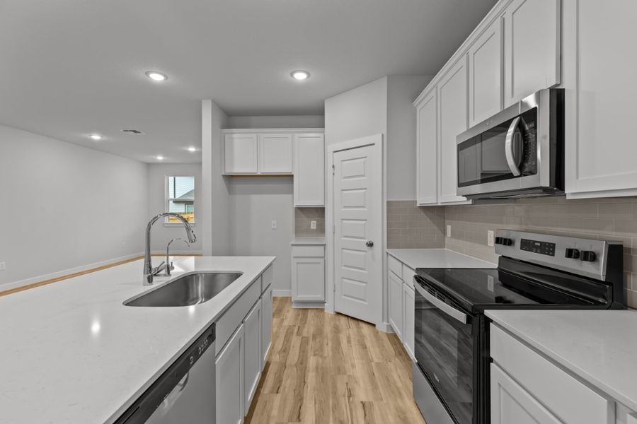 A kitchen with white cabinets. A kitchen with white cabinets.