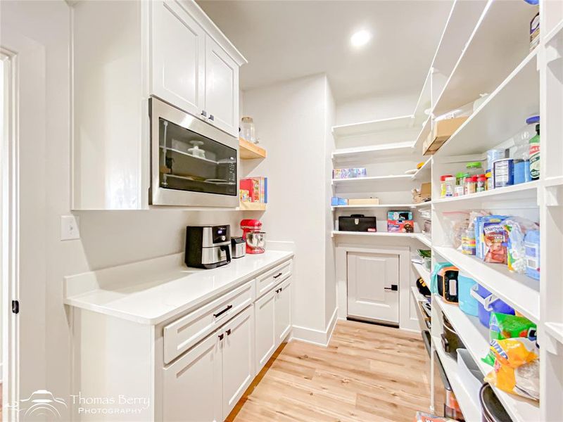 Oversized pantry has abundant space and houses the microwave!