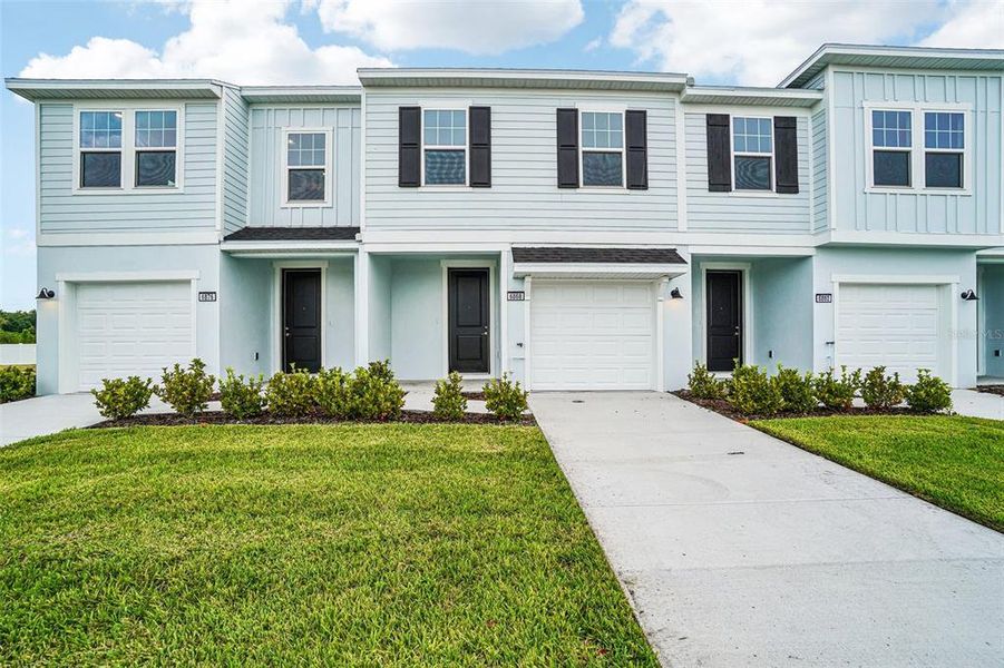 Front exterior of a new home in Twin Oaks, Zephyrhills, FL, highlighting curb appeal (Image 1). Front exterior of a new home in Twin Oaks, Zephyrhills, FL, highlighting curb appeal (Image 1).