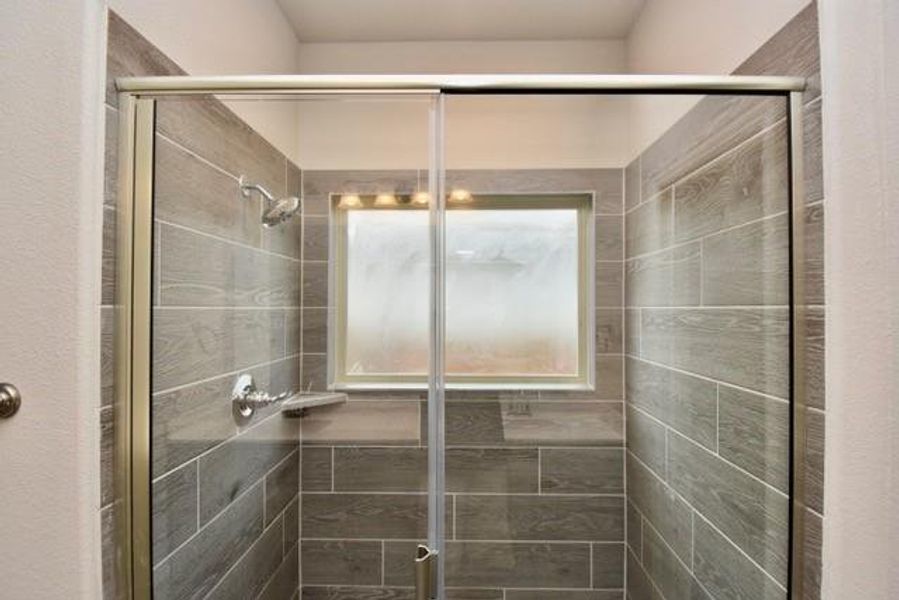Primary bathroom featuring a shower stall