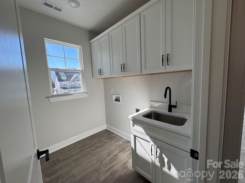 Laundry room with cabinets and sink