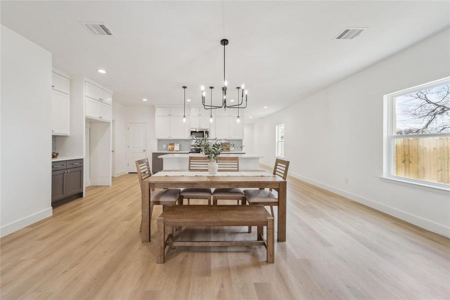 Dining room with a chandelier and light hardwood / wood-style flooring