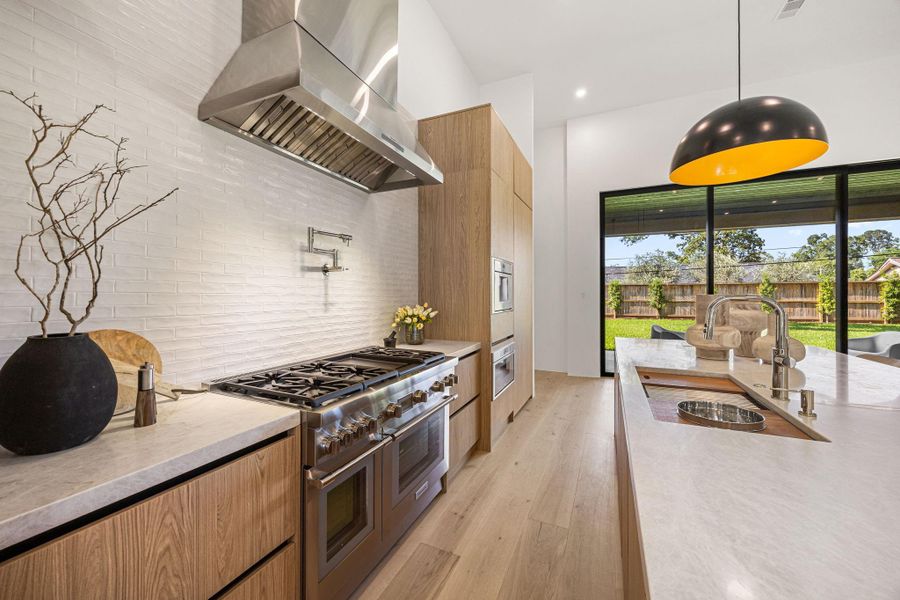 Contemporary custom cabinetry, designer fixtures & high-end Thermador appliance package create a knock-out kitchen. Built-in coffee maker & microwave offer a sleek look.