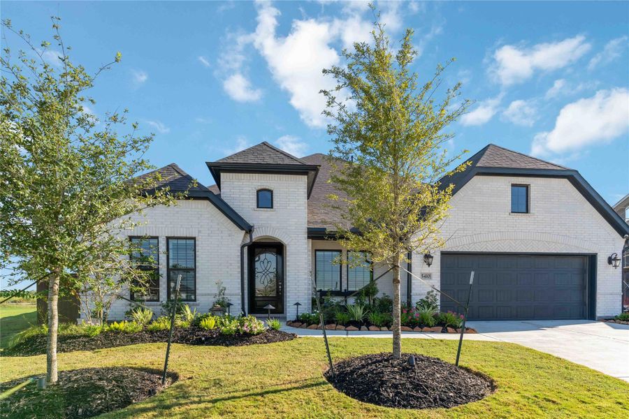 Shea Home Plan 5039 Elevation D with upgraded landscape lighting. Shea Home Plan 5039 Elevation D with upgraded landscape lighting.