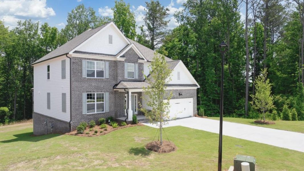 Front exterior of a new home in Thalley Creek Estates, Cumming, GA, highlighting curb appeal (Image 2). Front exterior of a new home in Thalley Creek Estates, Cumming, GA, highlighting curb appeal (Image 2).