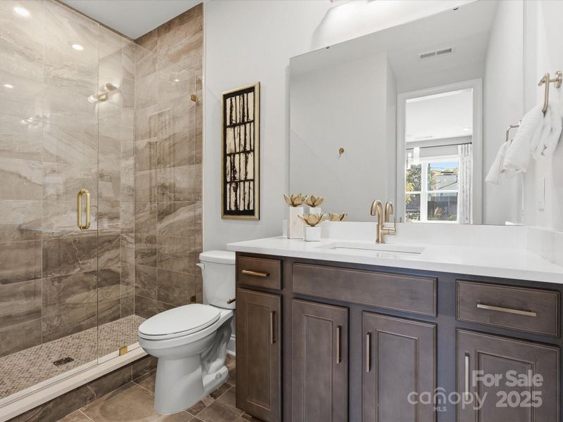 First Floor Full Bath with Stunning Modern Tile Design. *Model Photos | Actual Finishes, Structural Selections, and Orientation May Vary.