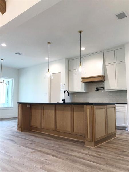 The kitchen flows seamlessly into the breakfast dining area and living room