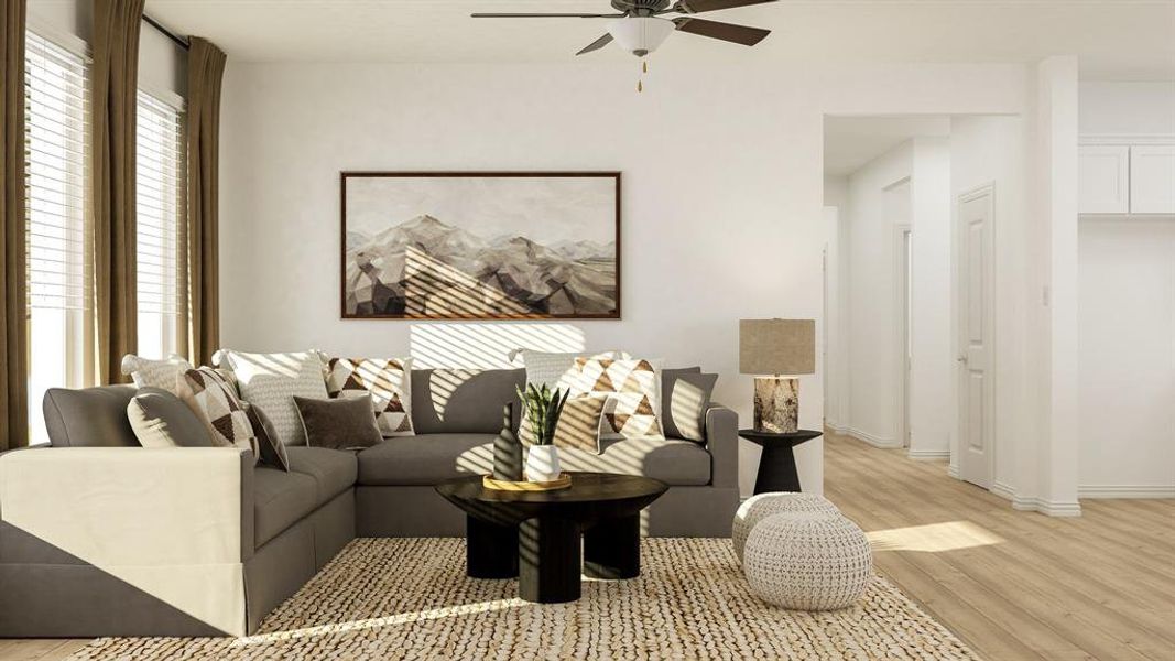 Living room with ceiling fan and light hardwood / wood-style floors