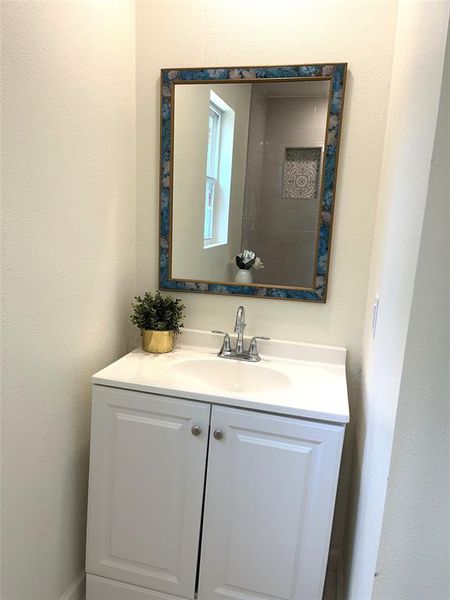 White vanity cabinet with an integrated sink and chrome faucet