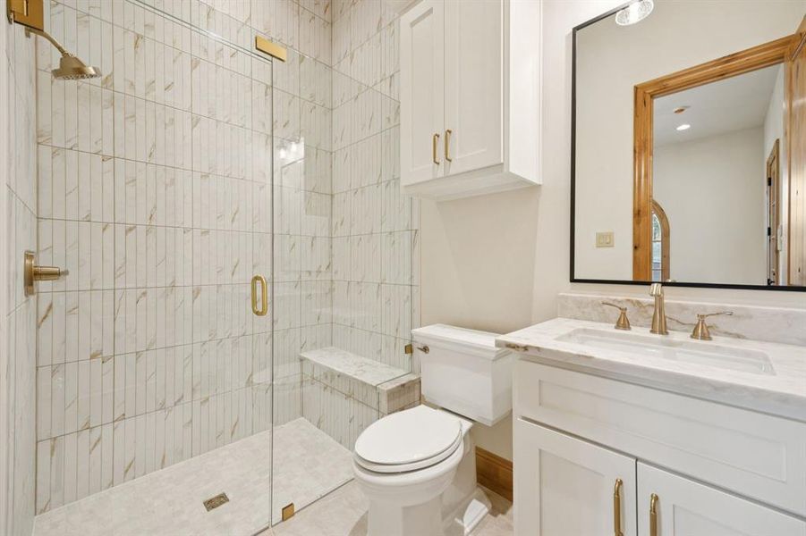 Bathroom featuring a stall shower and vanity