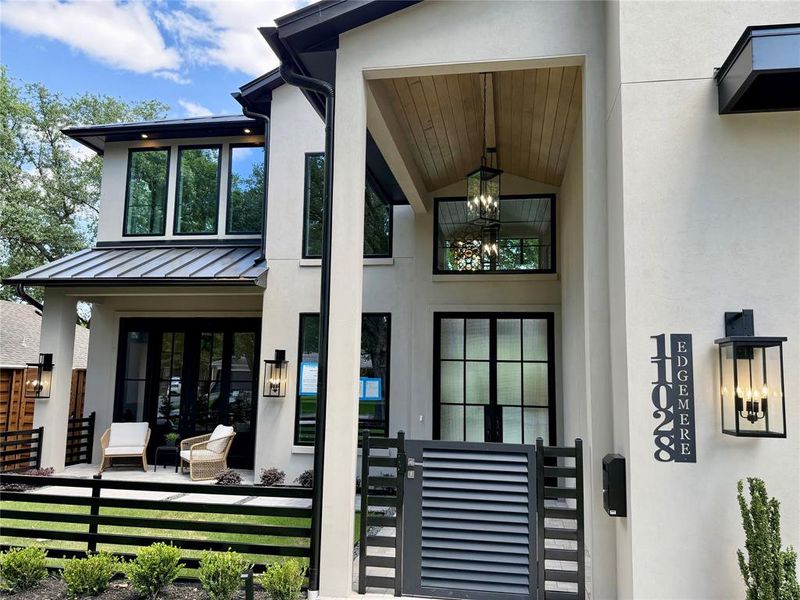 Contemporary exterior with a smooth stucco finish and prominent black-framed windows Contemporary exterior with a smooth stucco finish and prominent black-framed windows