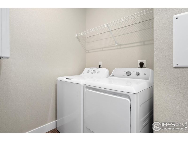 Dedicated laundry room with built in shelving