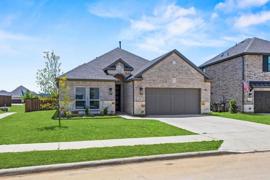 Front exterior of a new home in , Little Elm, TX, highlighting curb appeal (Image 2). Front exterior of a new home in , Little Elm, TX, highlighting curb appeal (Image 2).
