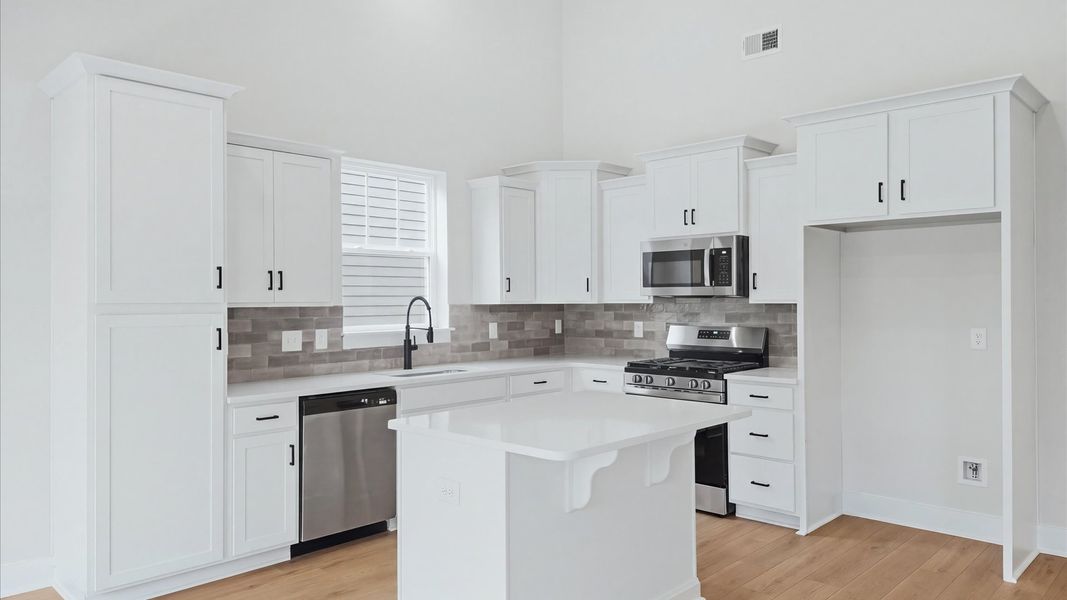 Memorable meals begin in this vibrant kitchen with a thoughtfully designed island at Creeks at Midway
