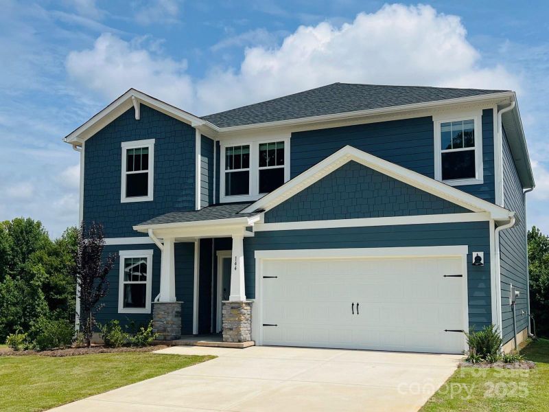 Front exterior of a new home in Sutter's Mill, Mooresville, NC, highlighting curb appeal (Image 2). Front exterior of a new home in Sutter's Mill, Mooresville, NC, highlighting curb appeal (Image 2).