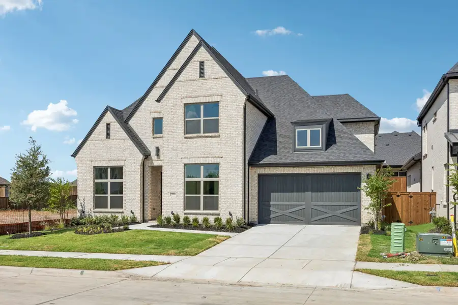 Front exterior of a new home in The Parks at Wilson Creek, Celina, TX, highlighting curb appeal (Image 2). Front exterior of a new home in The Parks at Wilson Creek, Celina, TX, highlighting curb appeal (Image 2).