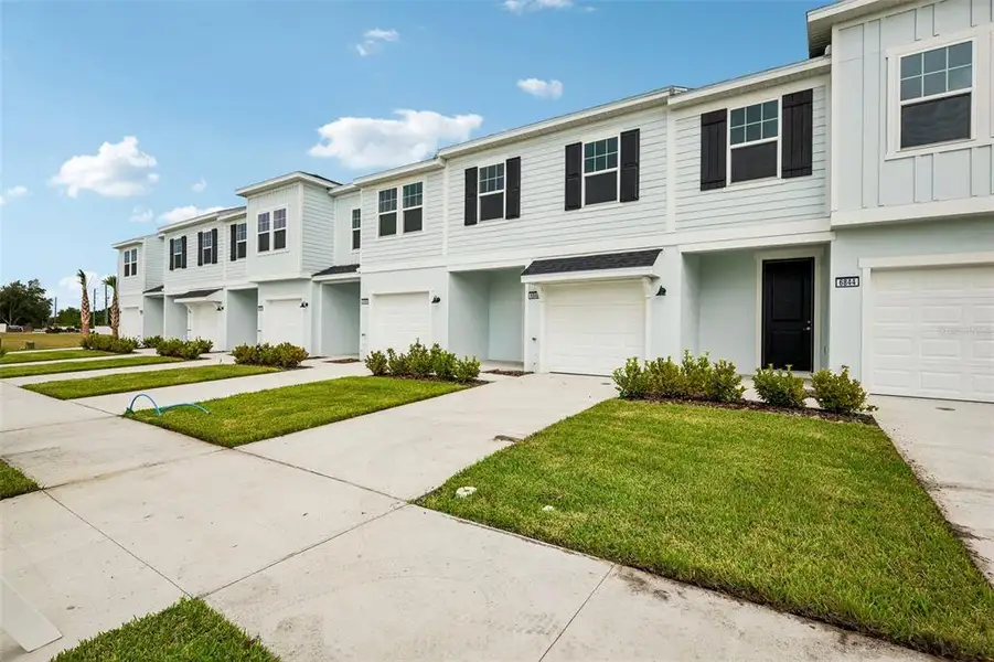 Front exterior of a new home in Twin Oaks, Zephyrhills, FL, highlighting curb appeal (Image 2). Front exterior of a new home in Twin Oaks, Zephyrhills, FL, highlighting curb appeal (Image 2).