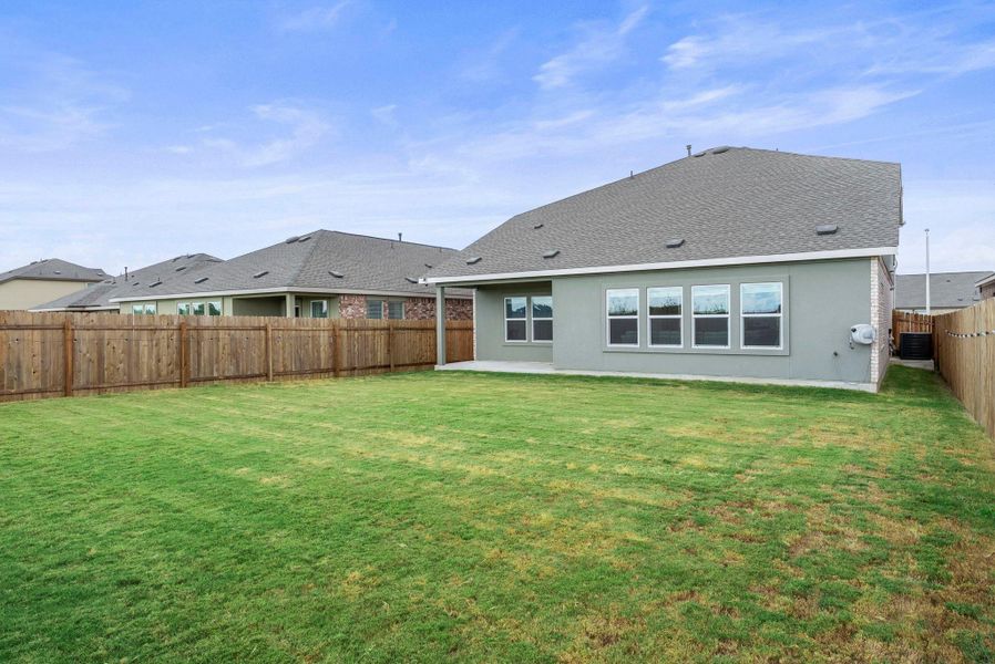 A spacious backyard with a lush green lawn, fully fenced for privacy and outdoor enjoyment. A spacious backyard with a lush green lawn, fully fenced for privacy and outdoor enjoyment.
