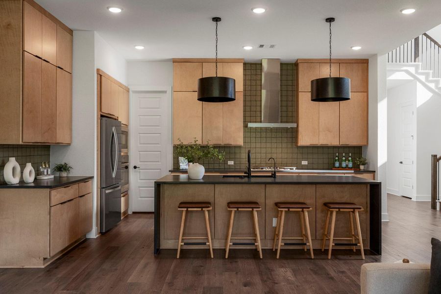 A contemporary kitchen boasts a spacious island and sleek cabinetry, perfect for entertaining.