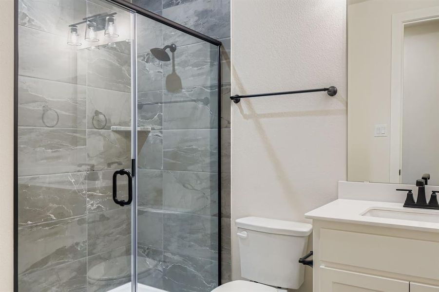 Full bathroom with vanity and a stall shower