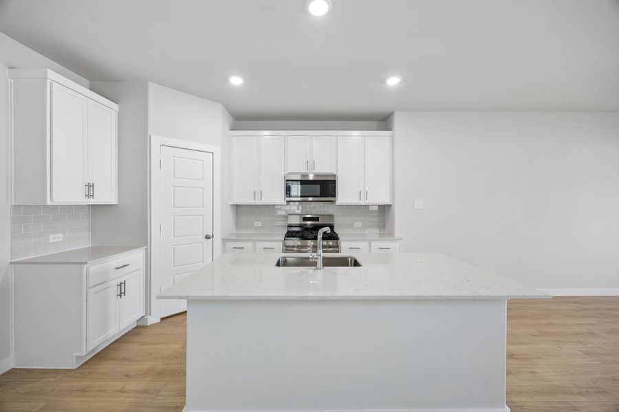 Kitchen in the Birch home plan by Trophy Signature Homes – REPRESENTATIVE PHOTO