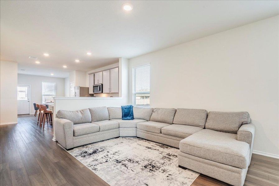 Living room features recessed lighting and LVP flooring Living room features recessed lighting and LVP flooring