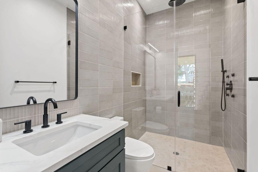 A well-appointed bathroom with a spacious walk-in shower and modern fixtures awaits. A well-appointed bathroom with a spacious walk-in shower and modern fixtures awaits.
