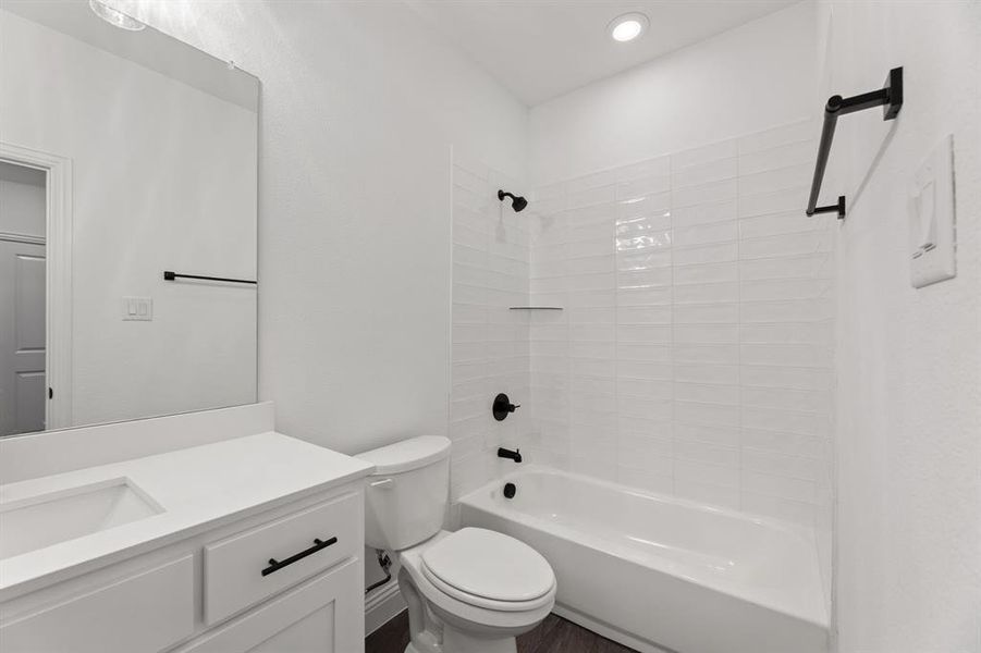 Bathroom featuring bathing tub / shower combination and vanity Bathroom featuring bathing tub / shower combination and vanity