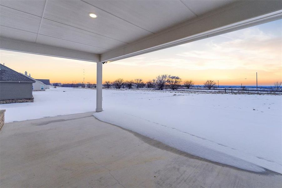 Snow covered patio featuring a patio area Snow covered patio featuring a patio area
