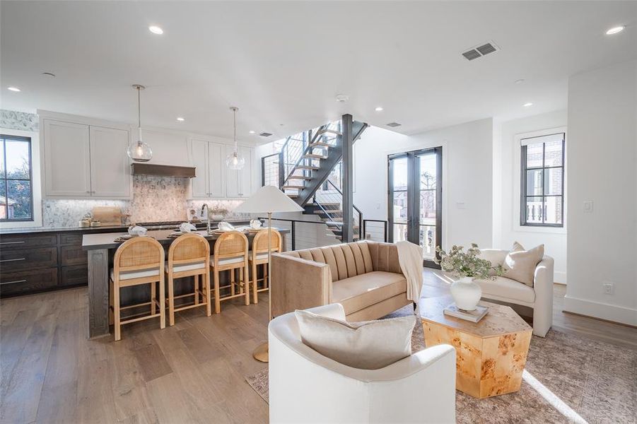 Living room with french doors and light hardwood / wood-style flooring