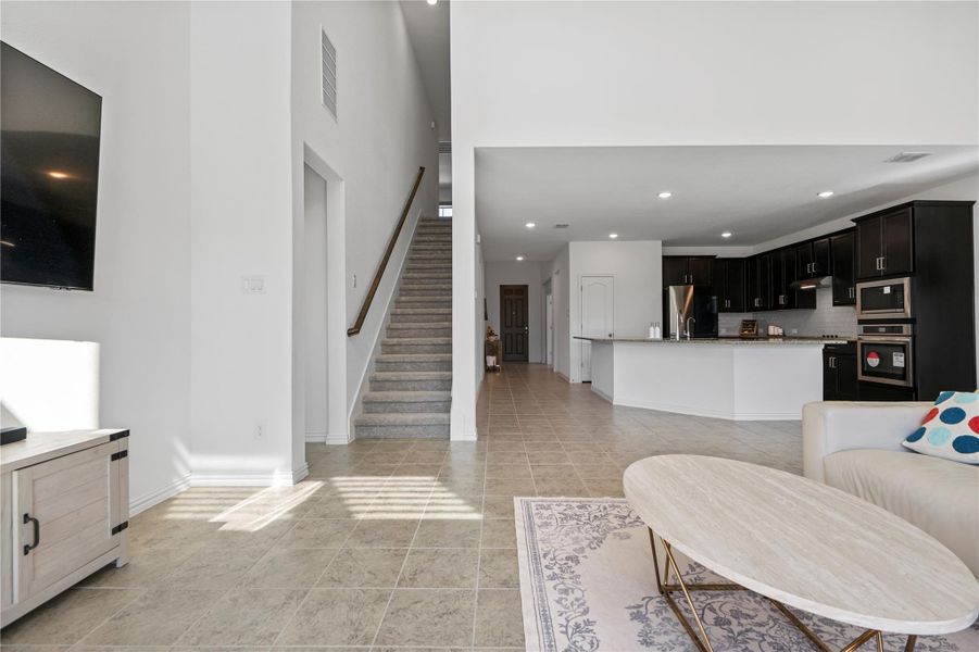 An open concept living area transitions seamlessly into a well-appointed kitchen. An open concept living area transitions seamlessly into a well-appointed kitchen.