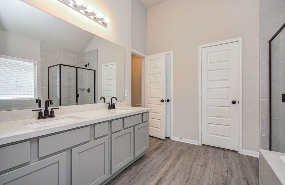 Wonderful primary bath with dual quartz vanities and extended mirrior