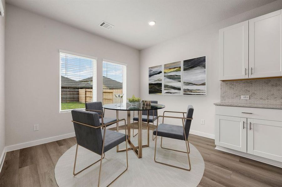 Make memories gathered around the table with your family and friends! This dining room features high ceilings, recessed lighting, large windows with blinds, EVP flooring.