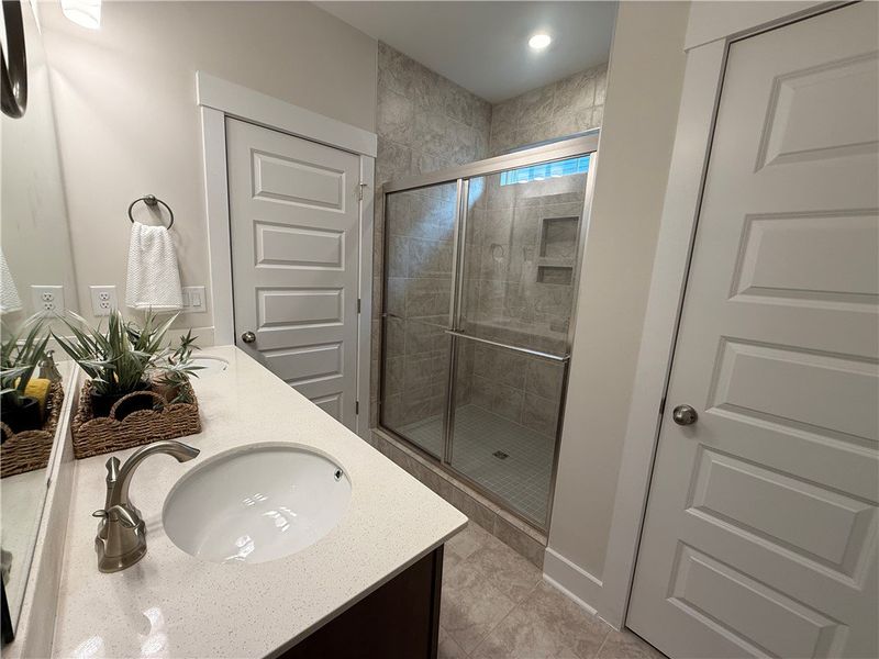 This bathroom features elegant counters, a glass-e