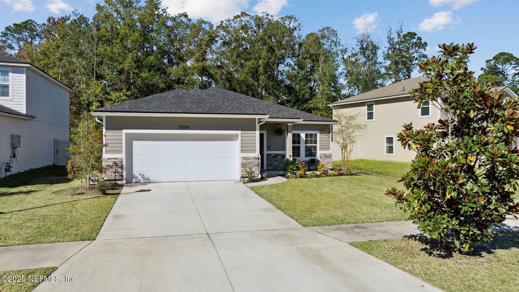 Front exterior of a new home in Wilford Preserve, Orange Park, FL, highlighting curb appeal (Image 22). Front exterior of a new home in Wilford Preserve, Orange Park, FL, highlighting curb appeal (Image 22).